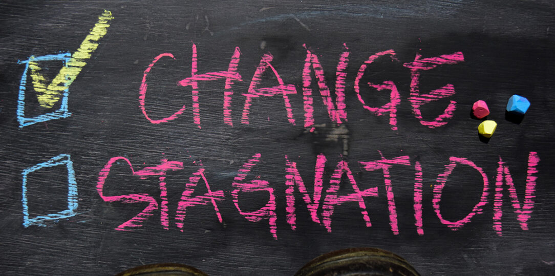 Change or Stagnation written with color chalk concept