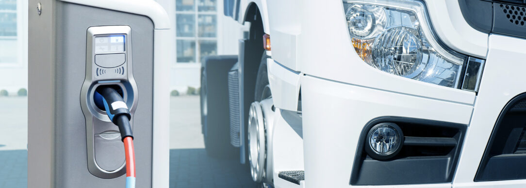 cropped view of an electric semi truck parked at a charging station