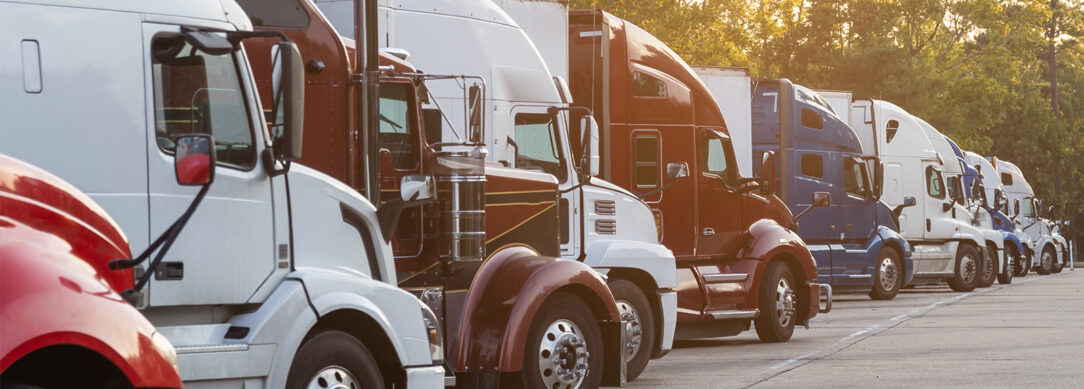 header image of semi-trucks lined up neatly in a lot.